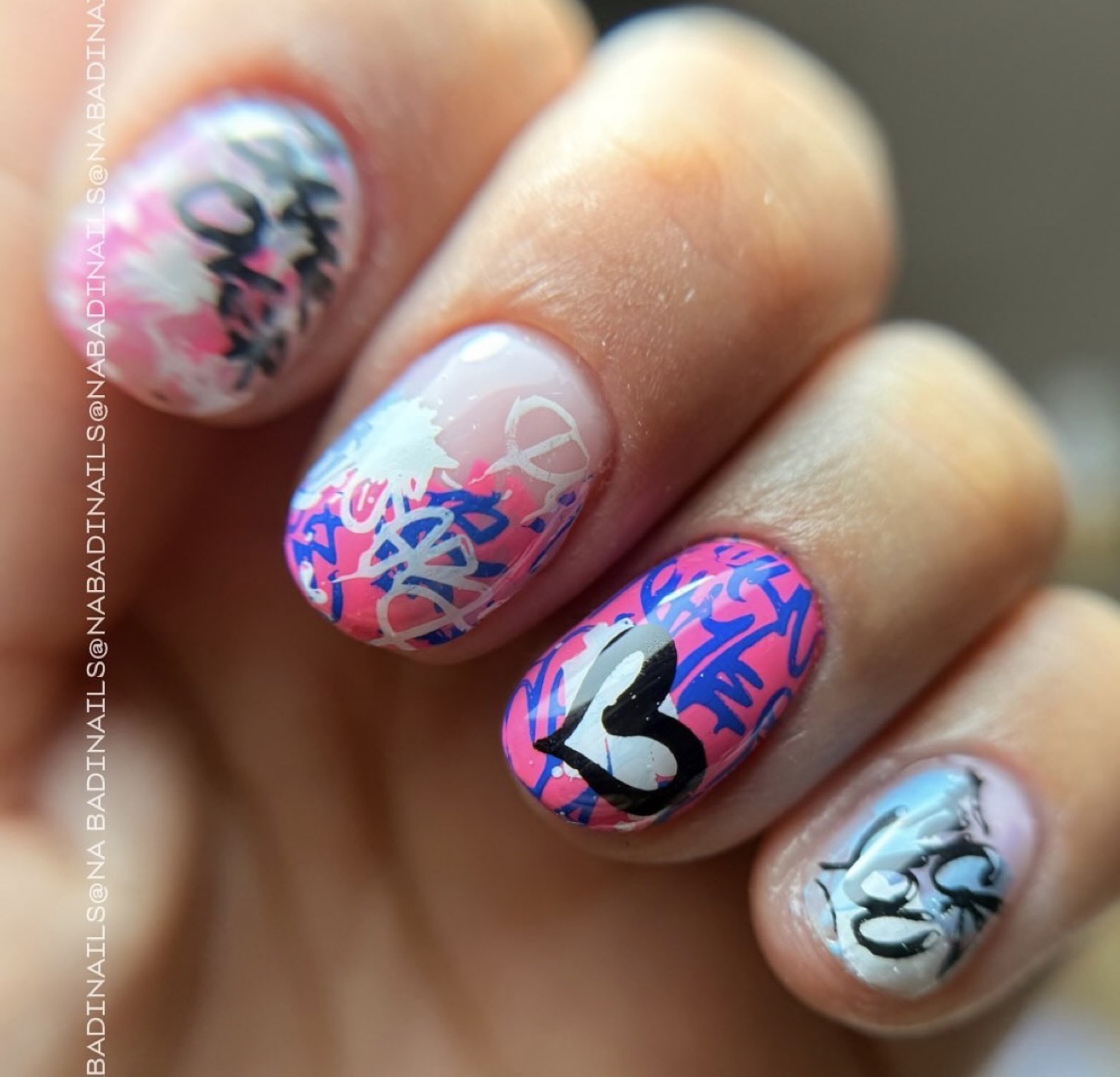 Diseño de uñas estilo graffiti rosa, azul y blanco